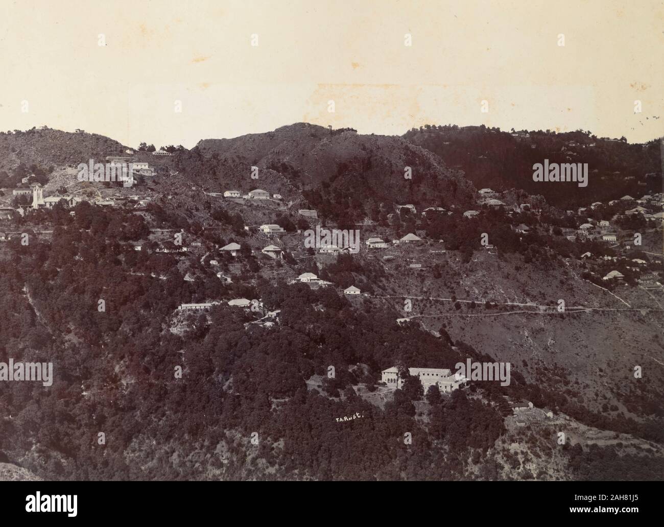 India, Houses cling to the forested mountainside at Mussoorie hill ...