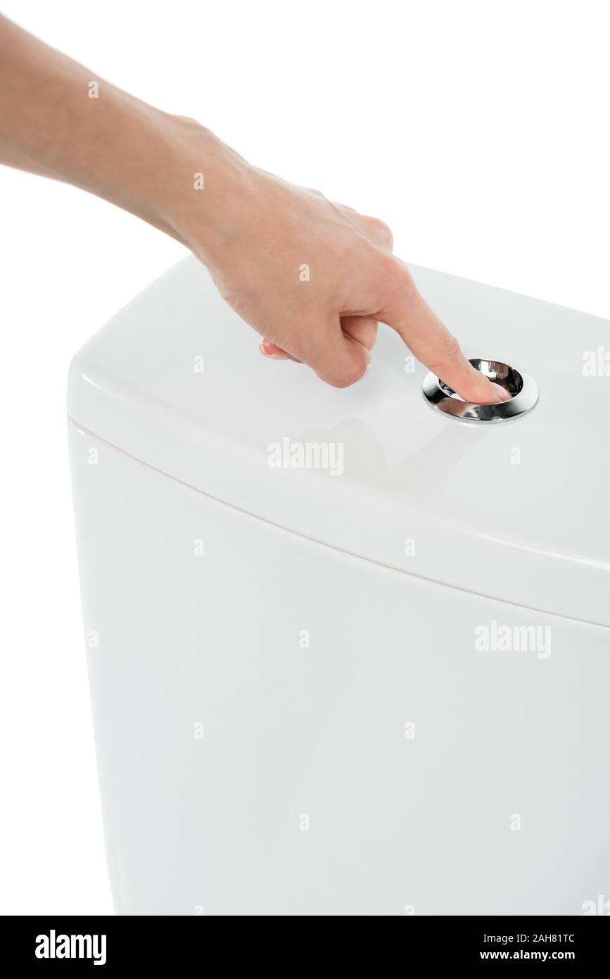 copped view of woman pushing flushing button on ceramic clean toilet bowl isolated on white Stock Photo