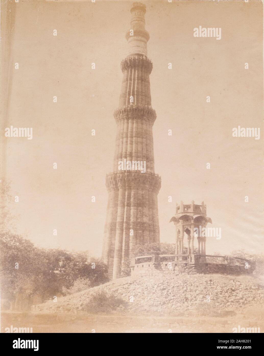 India, View of the Qutb Minar, one of the greatest monuments of Islamic architecture in India. At 72.5 metres tall, the celebratory victory tower was built to accompany the Quwwat-ul-Islam mosque, and was probably inspired by the style of Afghan minarets. Original manuscript caption: The Kutub near Delhi, circa 1890. 2003/071/1/1/2/55. Stock Photo