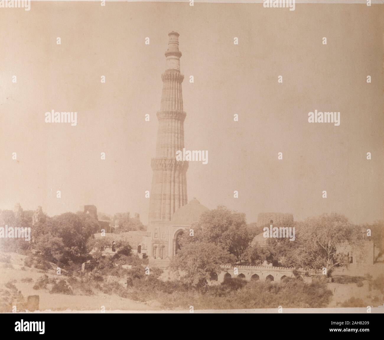 India, View of the Qutb Minar, one of the greatest monuments of Islamic architecture in India. At 72.5 metres tall, the celebratory victory tower was built to accompany the Quwwat-ul-Islam mosque, and was probably inspired by the style of Afghan minarets. Original manuscript caption:The Kutub near Delhi, circa 1890. 2003/071/1/1/2/54. Stock Photo