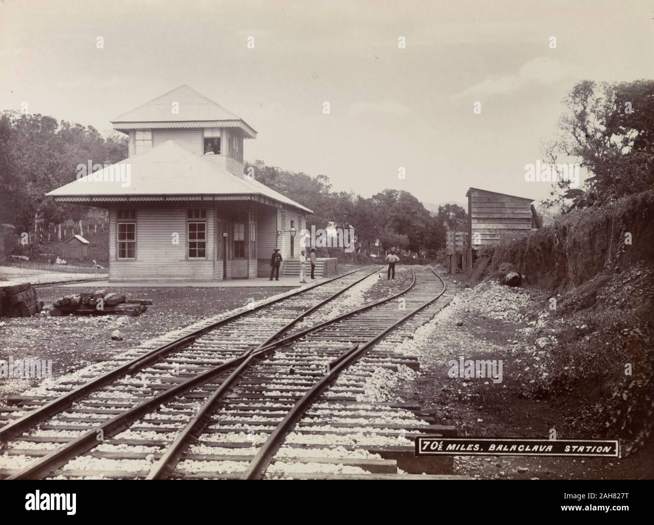 Jamaica, A group of men loiter on the platform and track outside
