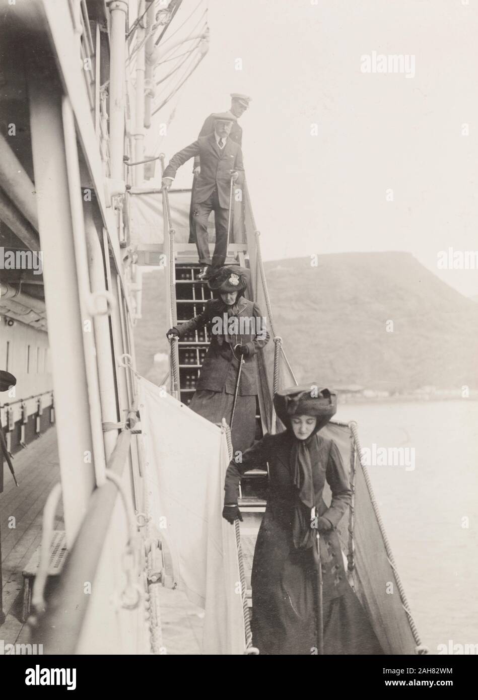 St Helena, The Duke and Duchess of Connaught and their daughter, Princess Patricia, disembark from the S.S. Balmoral Castle on their arrival in St Helena. This was one of several stops made by the royal couple on their way to Cape Town. 25 October 1910.Notes from a printed itinerary of the visit: Monday, October 24. 10 A.M. Saint Helena. Governor's Representative will call.11 A.M. to 12.30 P.M. Land and receive Address, Visit to Castle, Lace School and Hospital.Lunch on board (private)2.15 P.M. to 6 P.M. Visit to Longwood.Dinner, 'Balmoral Castle', 1910. 1995/076/1/4/1/15. Stock Photo