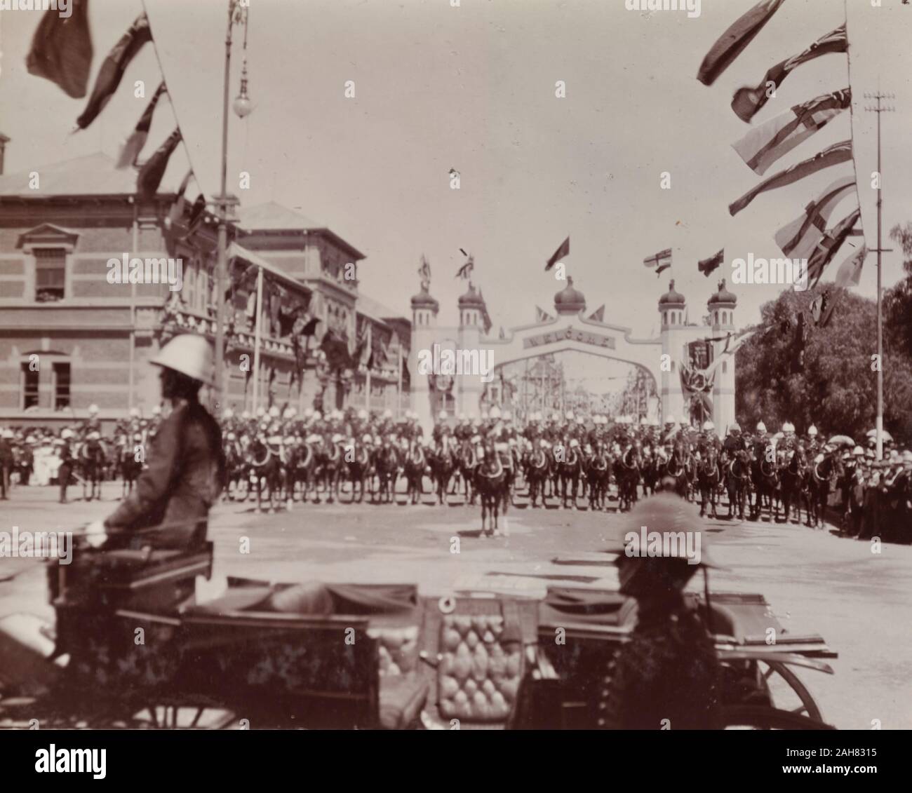 ZimbabweSouthern Rhodesia, A British cavalry regiment lines up for a parade held in honour of the Duke and Duchess of Connaught. The courtyard is decorated with flags from around the British Empire. Probably Salisbury, circa 17 November 1910.Notes from a printed itinerary of the visit:Thursday, November 17 (Public Holiday)Morning. Salisbury. Arrive.Drill Hall, Presentation of Address, Volunteer Review. Khaki Uniform.Afternoon. Government House, Reception, 1910. 1995/076/1/4/1/94. Stock Photo