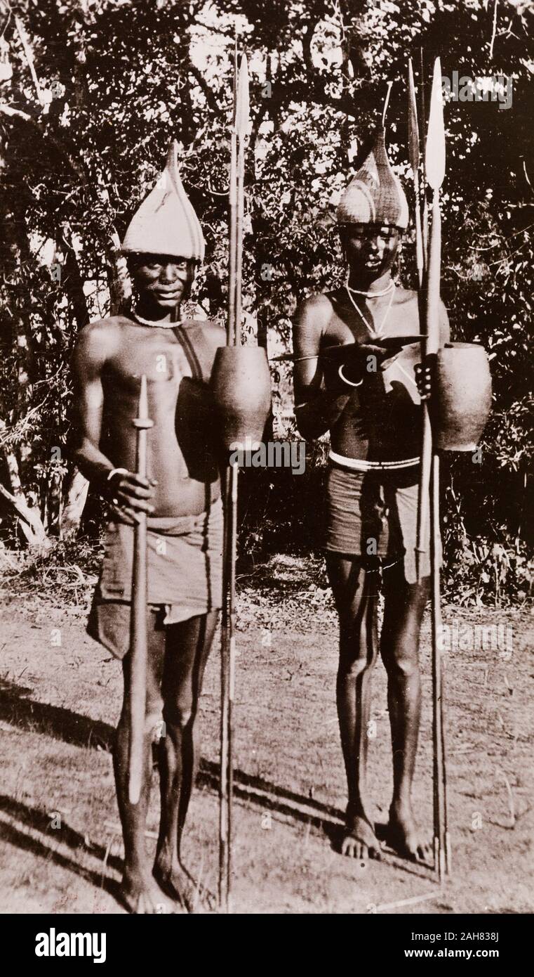 Sudan, Printed caption reads: 'Native Sheikhs, Bahr-el-Ghazal. Published by G N Morhig, The English Pharmacy, Khartoum. Copyright 165'. Two men in loin cloths and armed with spears pose for a photograph, [c.1906]. 2003/222/1/2/69. Stock Photo
