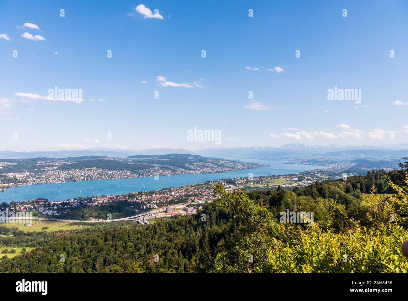 Panorama of  the of old downtown of Zurich city, with beautiful house at the bank of Lake of Zurich.  Aerial view from the the top of Mount Uetliberg Stock Photo