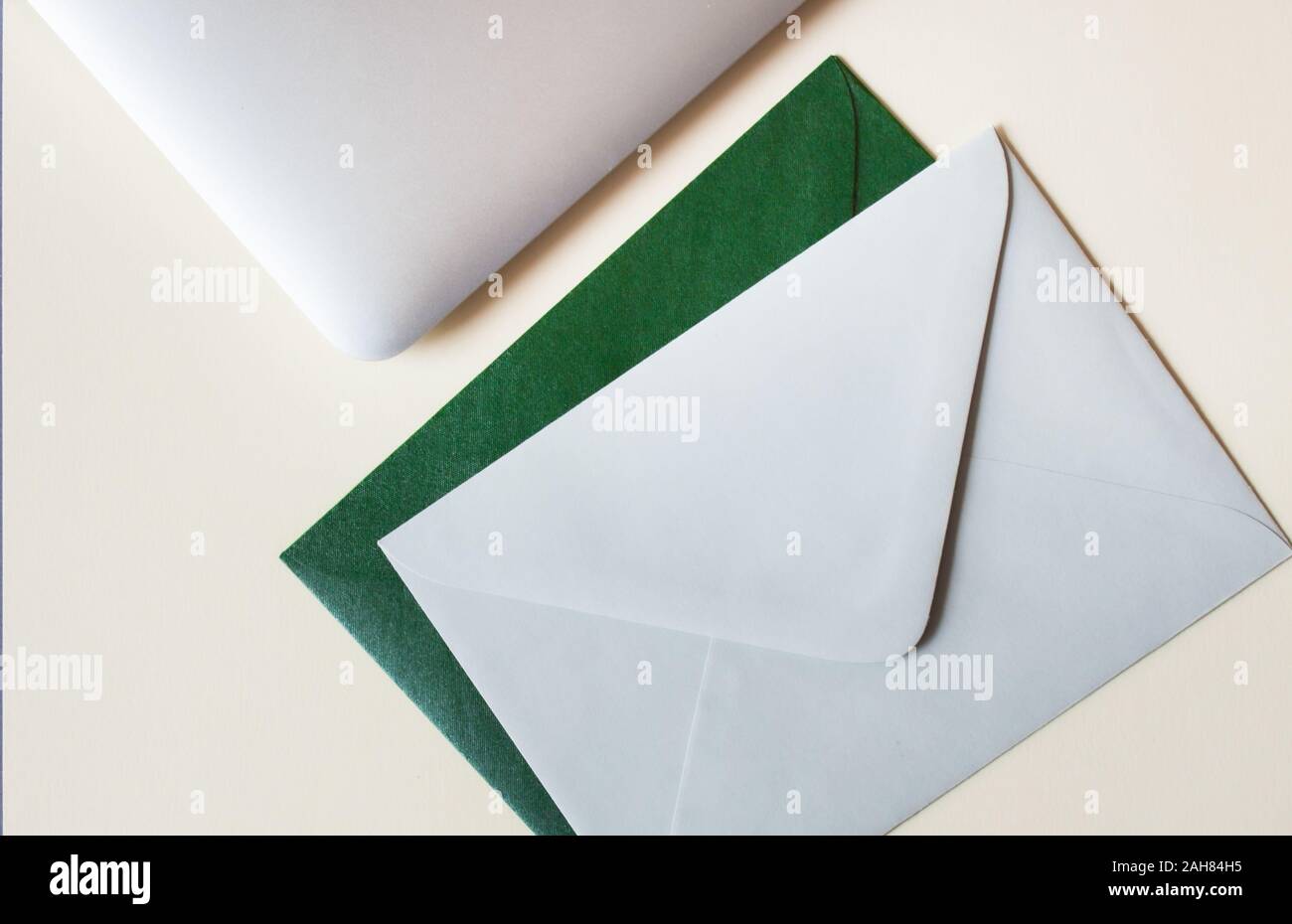 Colorful envelopes and laptop on table. Stock Photo