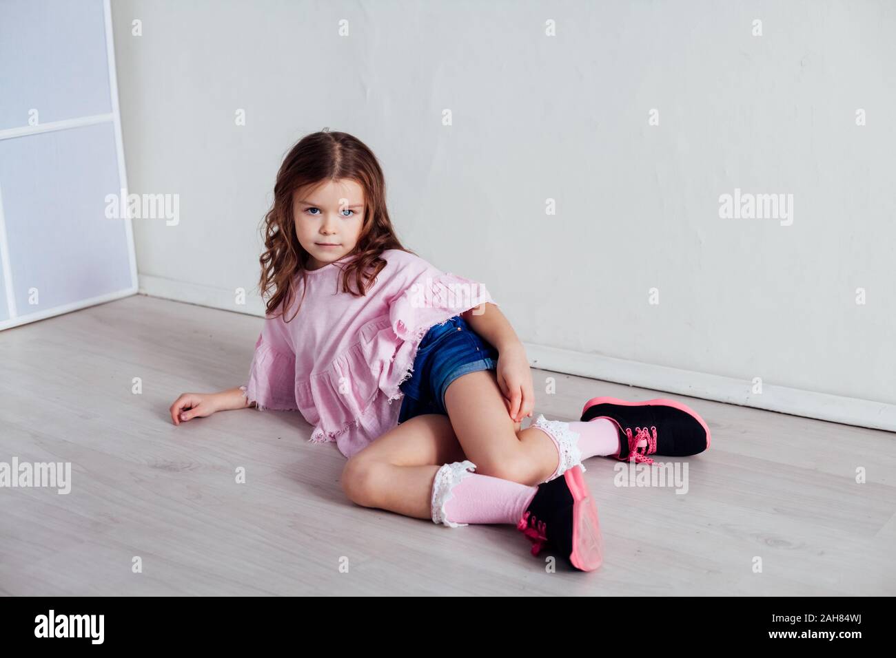 Portrait of a beautiful little girl in a pink dress five years