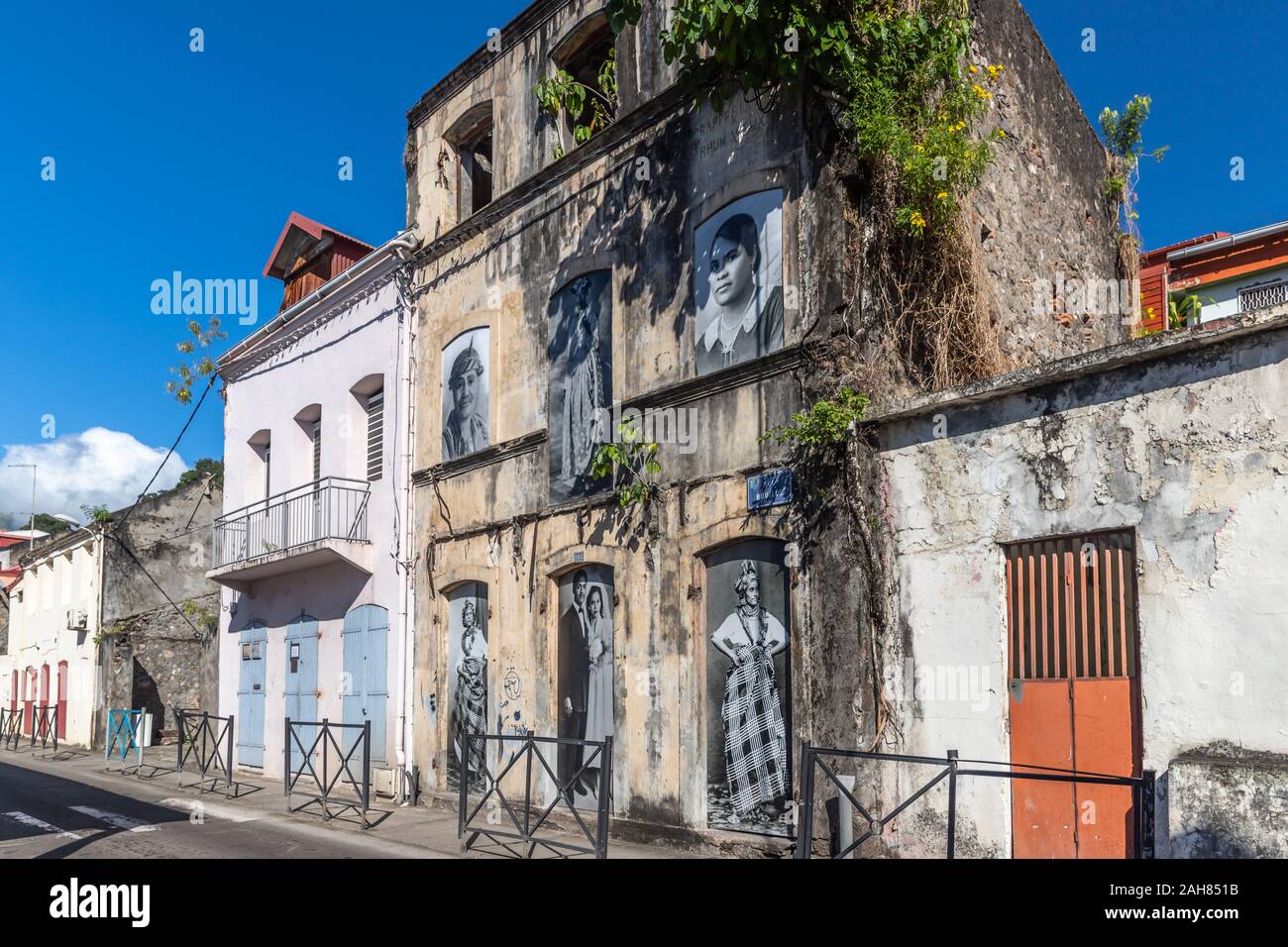 Old houses with pictures in windows in SaintPierre, Martinique, France