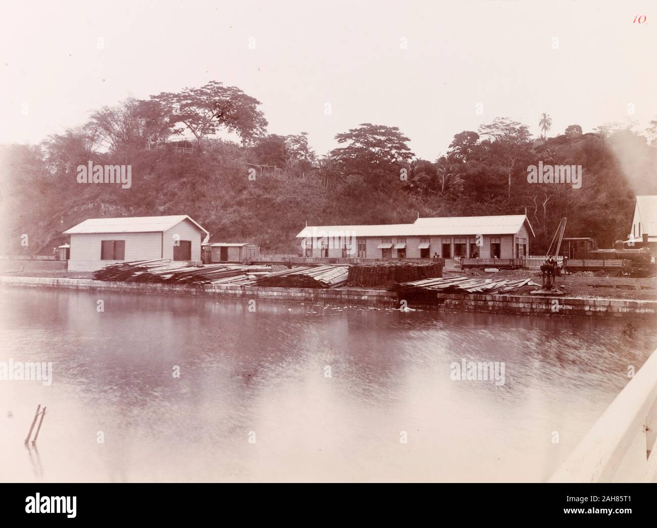 Trinidad & Tobago, View across a river looking towards San Fernando railway station, where a steam train waits on the tracks.Caption reads: San Fernando terminus, [c.1895]. 1999/221/1/25/10. Stock Photo