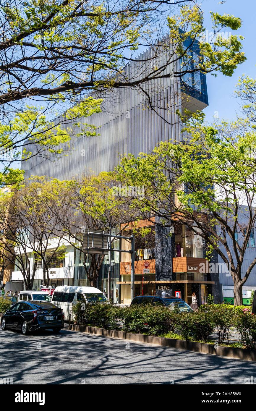 One Omotesando Building Designed By Kengo Kuma Foreground Omotesando Avenue With Springtime Trees With Building Behind Loewe Store On Corner Stock Photo Alamy