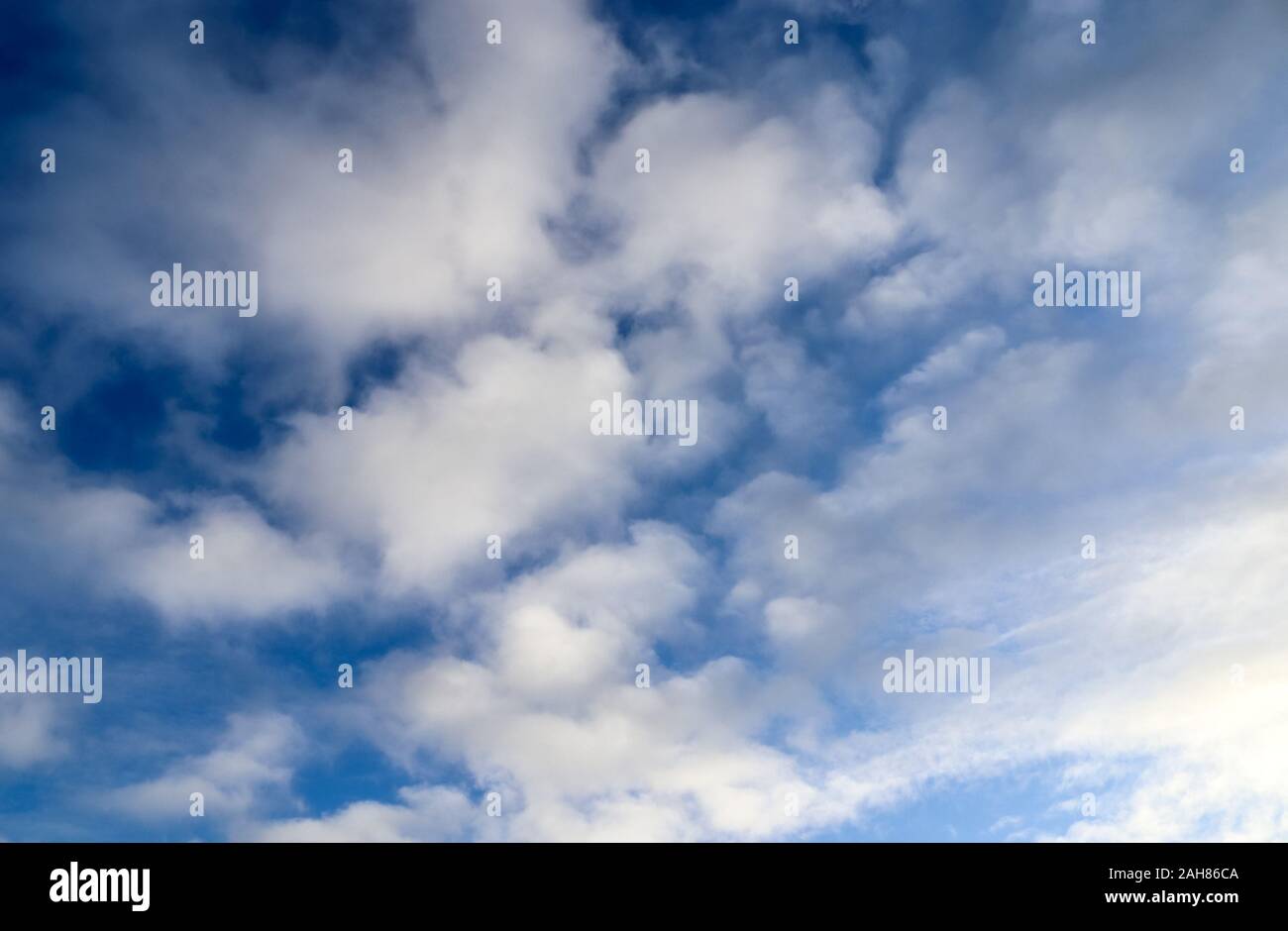 Beautiful and warm orange sunset clouds on a deep blue sky Stock Photo ...