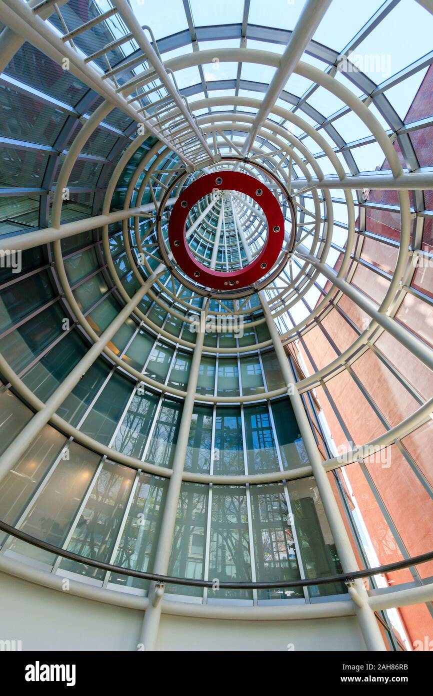 Interior of the Japanese Nursing Association Building, designed by Kisho Kurokawa. Looking up to the top of the glass cone tower. Omotesando, Tokyo. Stock Photo