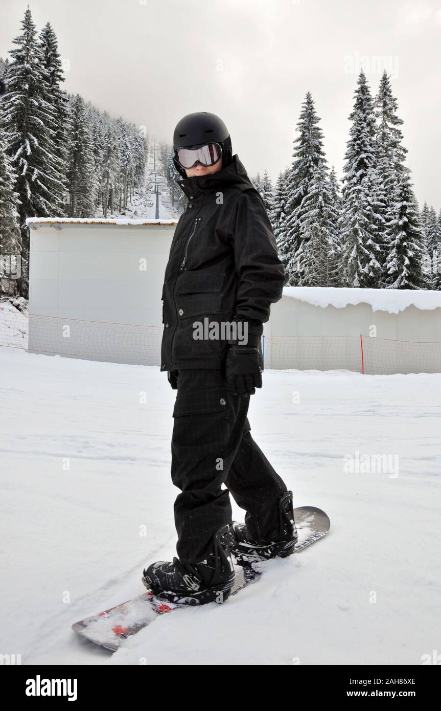 Ski skiing and snowboarding Lone young male snowboarder in black