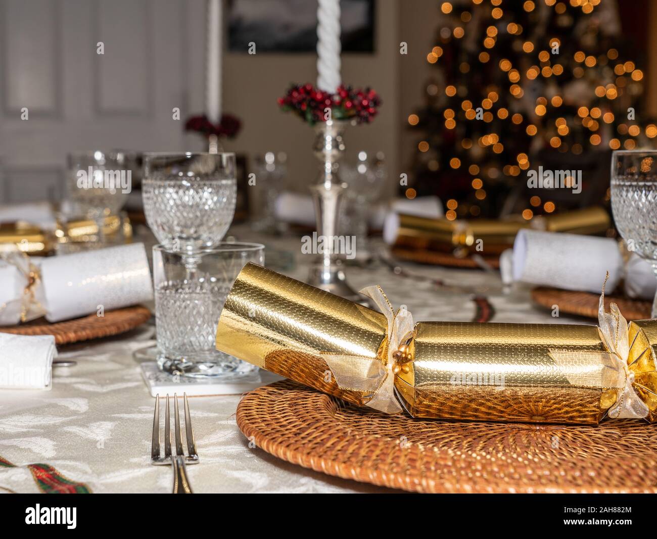Traditional british christmas lunch table setting with crackers and