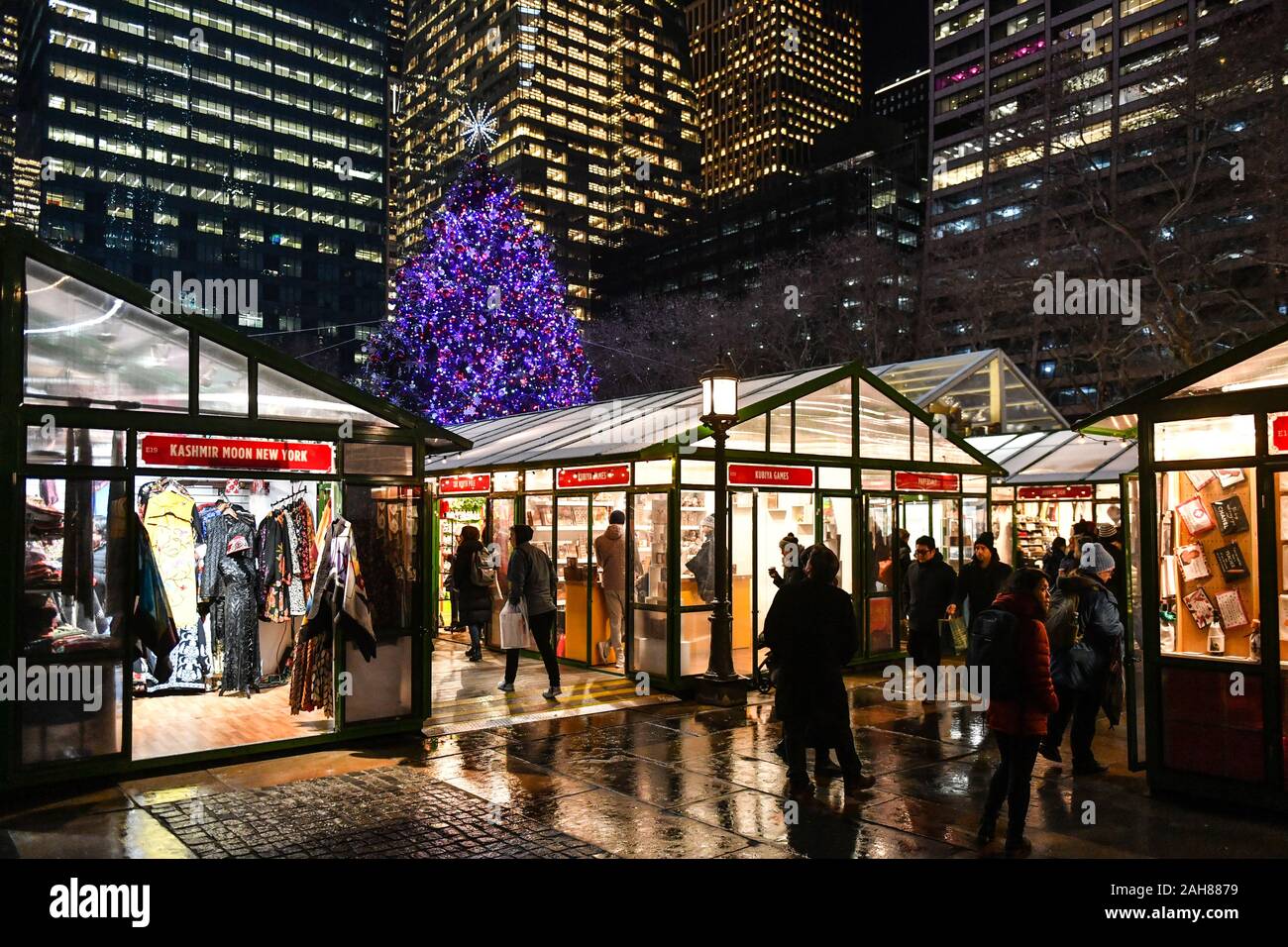 A Christmas Tree shines over the Winter Village and Holiday Shops at