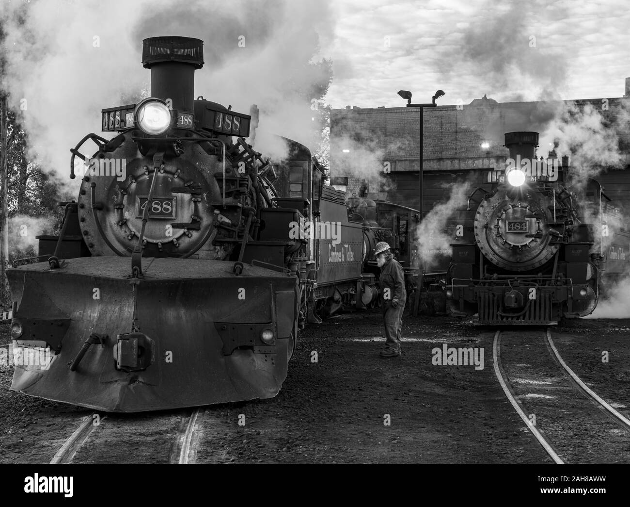 Steam engines and an engineer in the yard at Chama on the Cumbres and