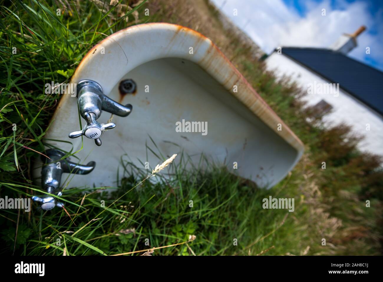 Close up of an abandoned english bath tube, with the chrome taps in the foreground Stock Photo
