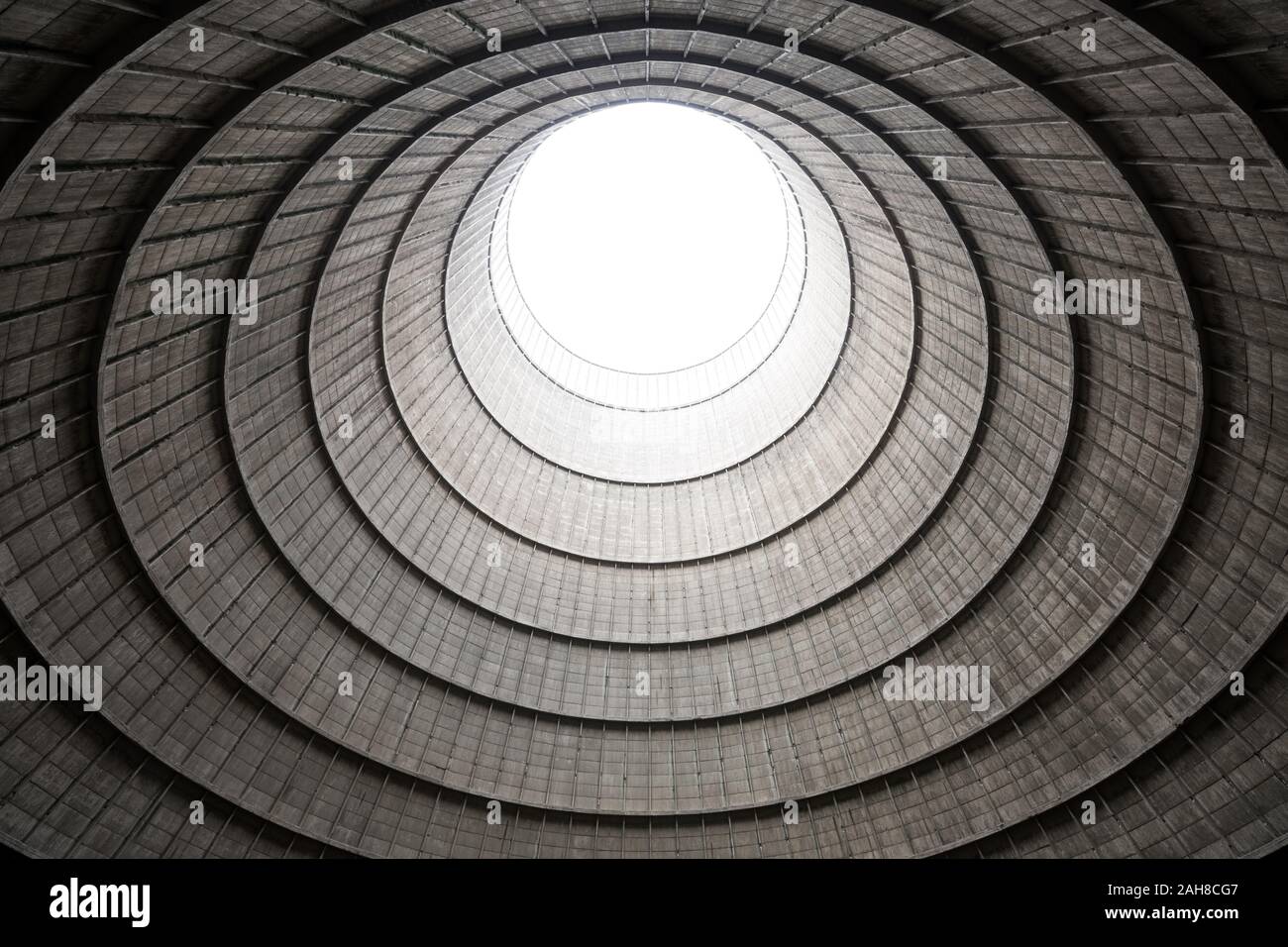 Symmetrical wide angle view of the geometric interior of a cooling tower as seen from below Stock Photo