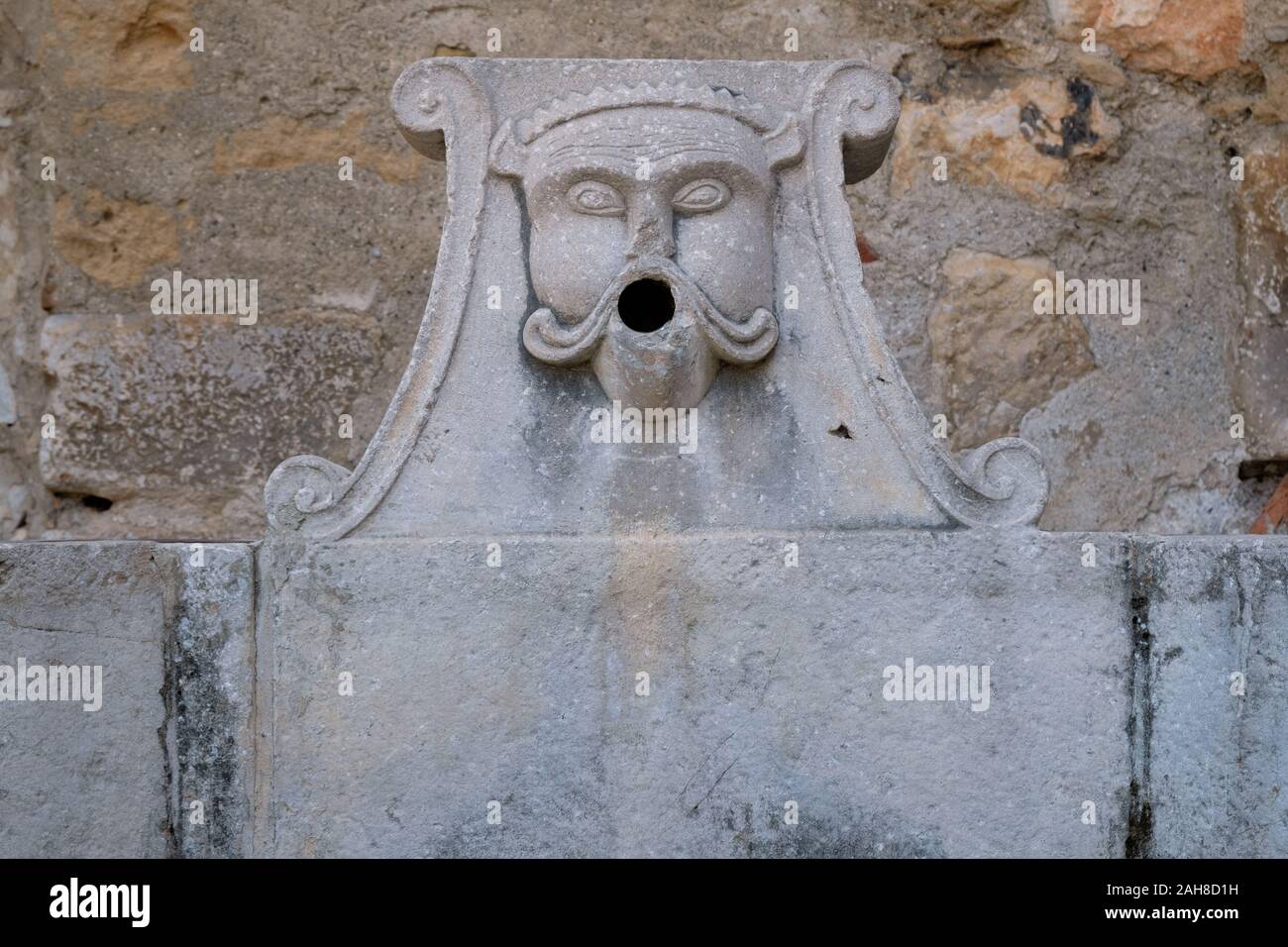 Dry fountain head in a exterior patio at the Real Monasterio de San Jerónimo de Granada in Granada, Spain. Stock Photo