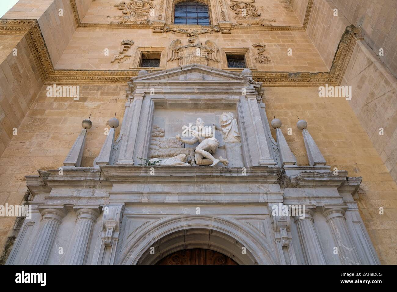 Sculpted depiction of St. Jerome on the exterior wall above the chapel's doorway at the Real Monasterio de San Jerónimo de Granada in Granada, Spain. Stock Photo