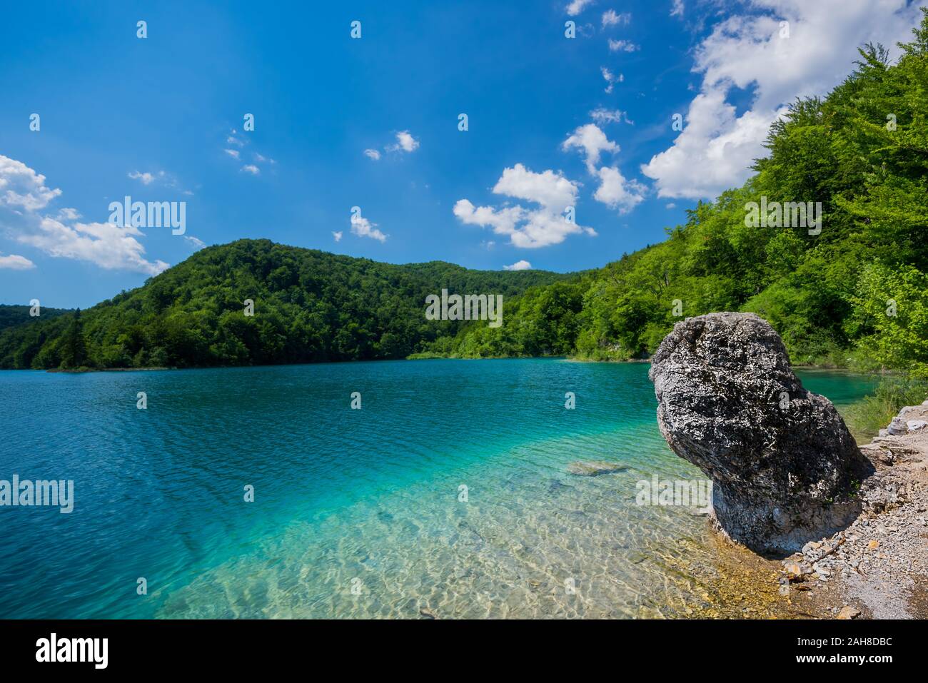 Wide angle view of a sandy beach with crystal clear water in Croatian waterfall park of Plitvice Stock Photo