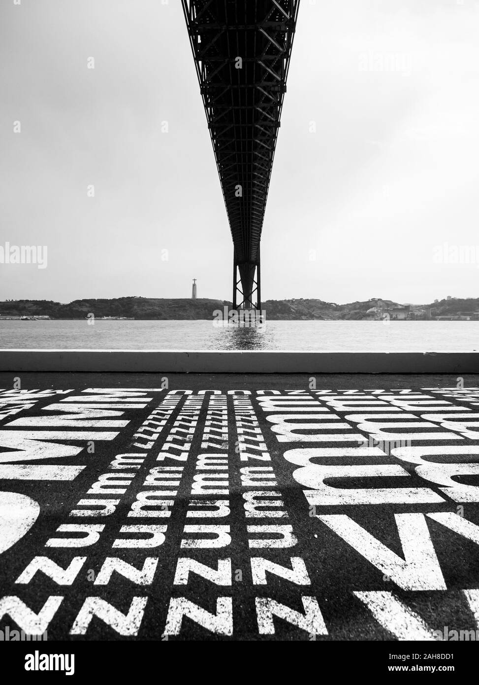 Black and white symmetrical wide angle view of the bridge celebrating April 25th in Lisbon Stock Photo