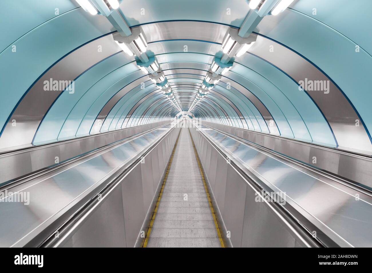 Symmetrical shot of a futuristic moving walkway in Saint Petersburg's underground system Stock Photo