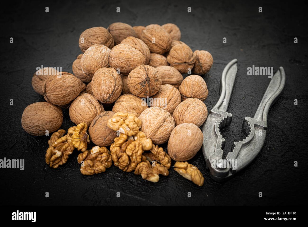 Walnut on over black slate stone background Stock Photo