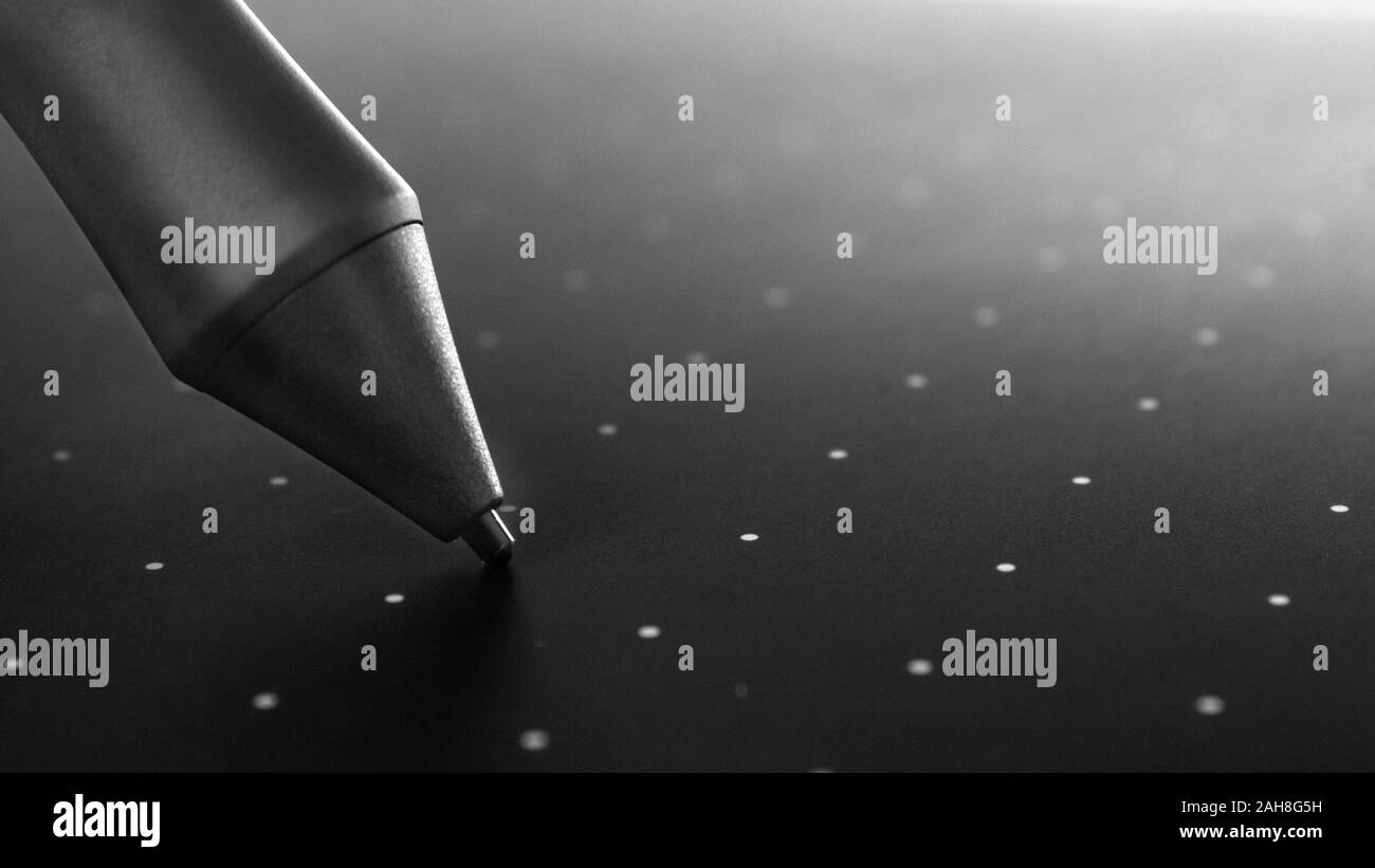 Graphic tablet pen on the surface of the device, closeup photo Stock