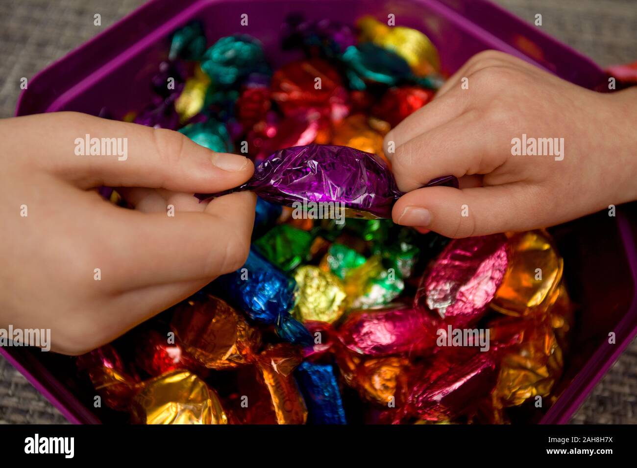 Fighting over favourite quality street chocolates Stock Photo