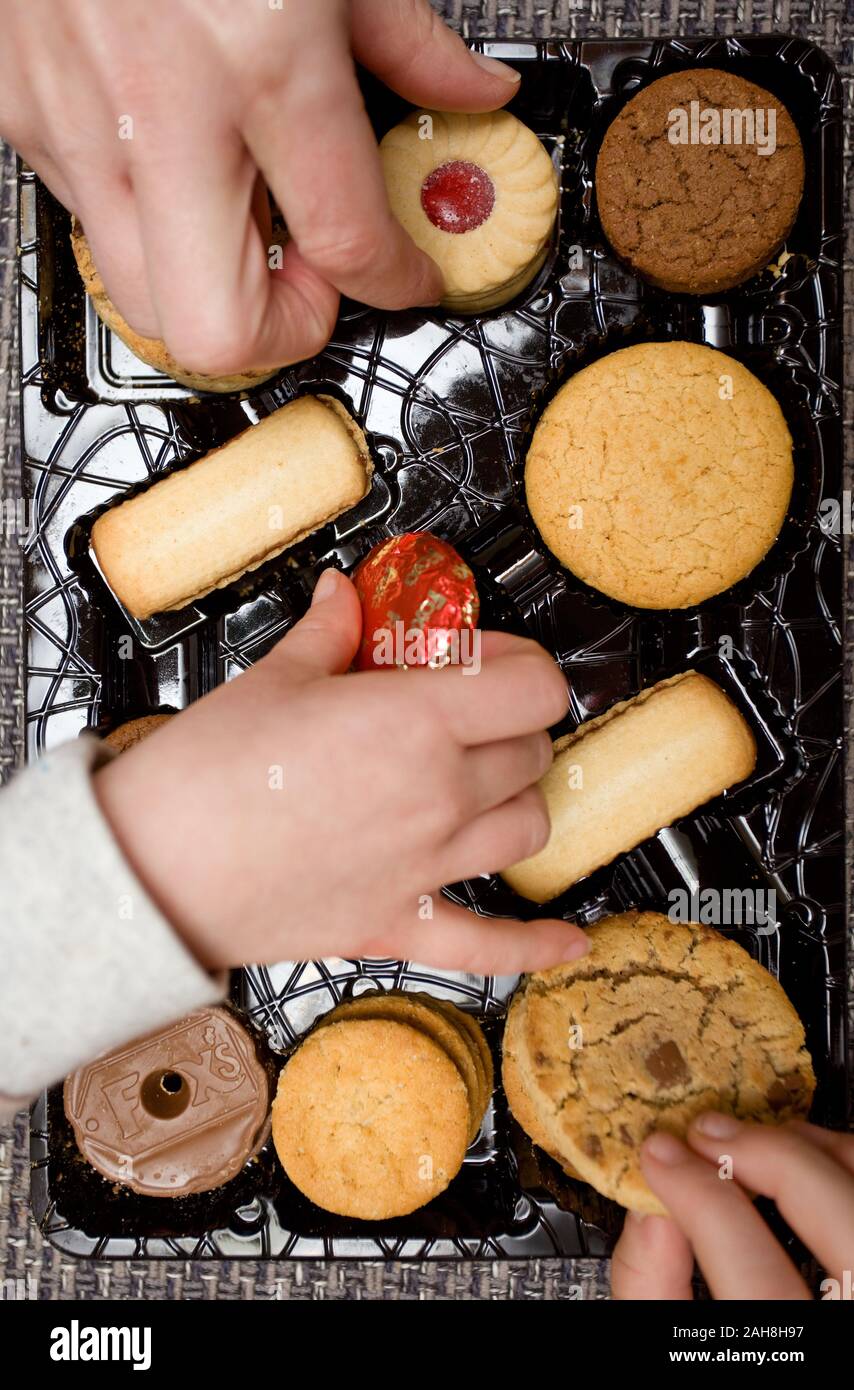 picking out favourite biscuits Stock Photo