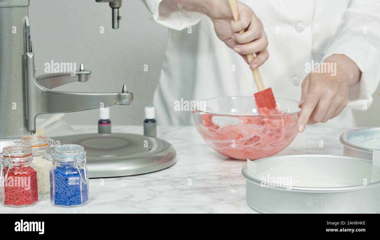 Step by step. Mixing food coloring into a cake batter to bake a three ...