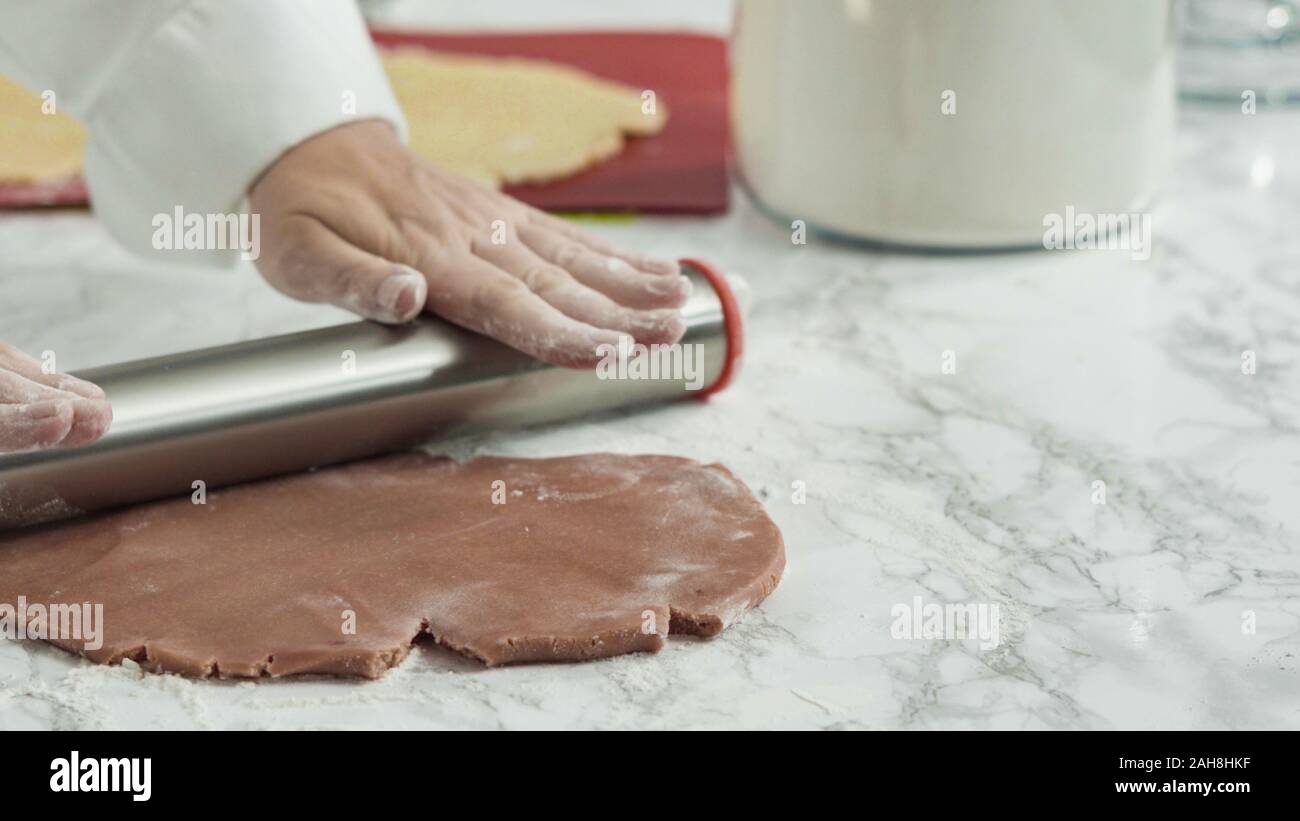 Step by step. Rolling out dough with a rolling pin to bake red, white ...