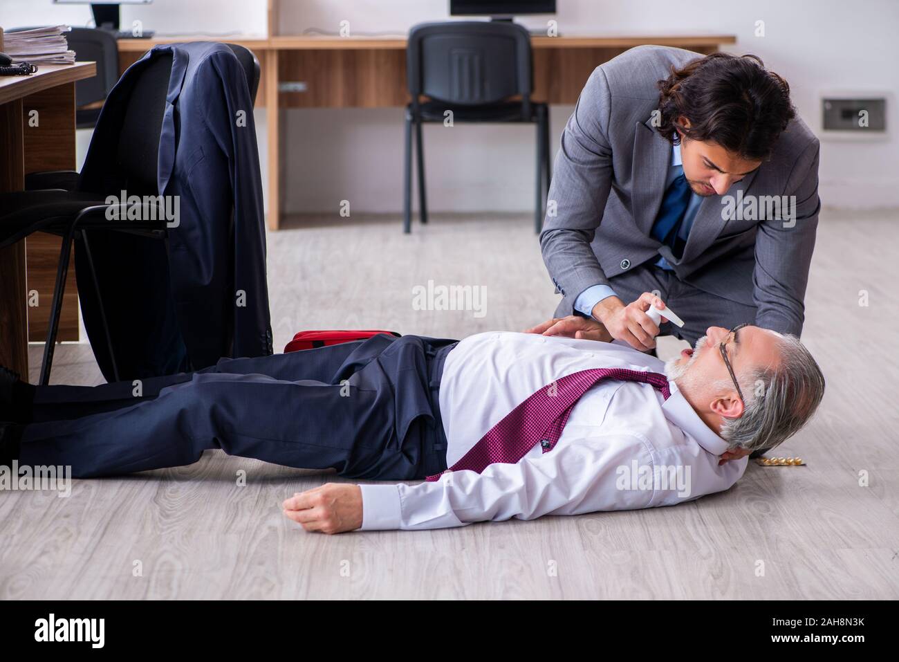 The male employee suffering from heart attack in the office Stock Photo