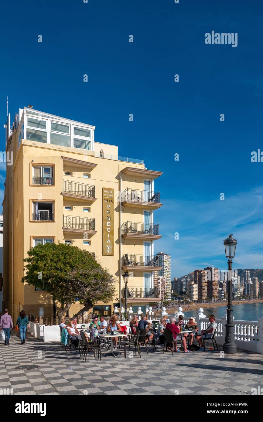 Benidorm, Costa Blanca, Spain, Hotel boutique, The Venecia, tourists on the Balcon enjoying the winter sun with a view of Levante Beach in the backgro Stock Photo