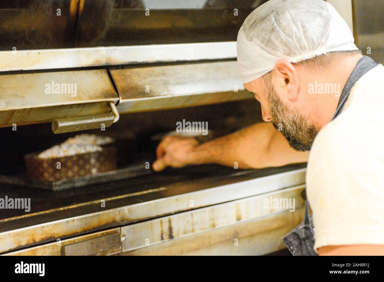 Adult strong man baking milanese traditional is an Italian