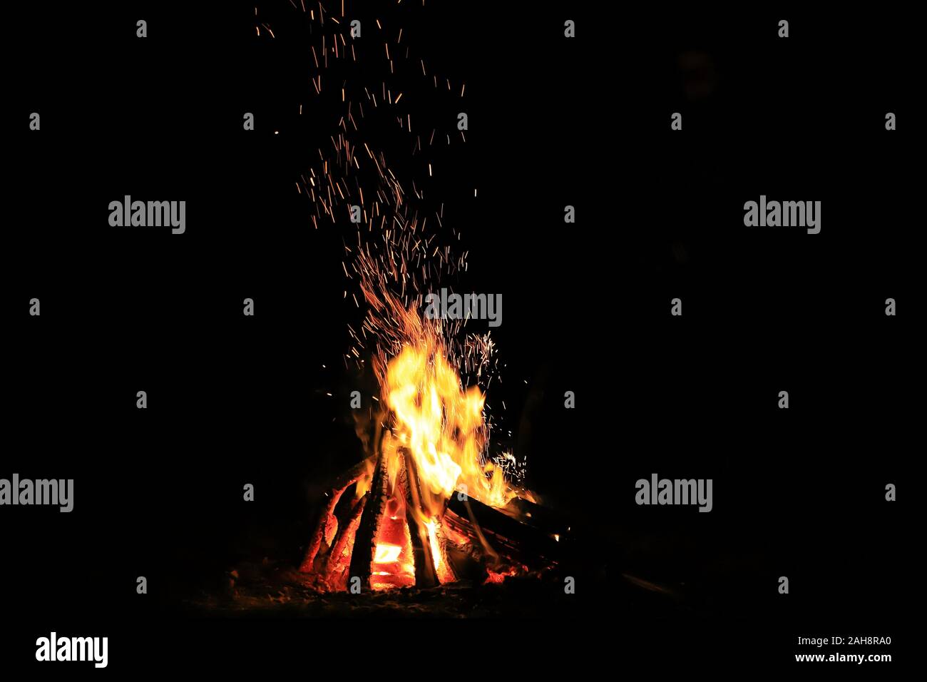 Bonfire with sparks and strong fire at night in total darkness Stock ...