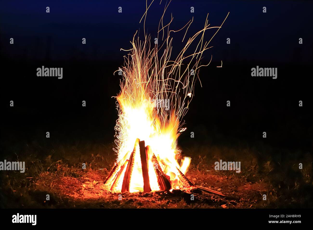 Bonfire with sparks and strong fire at night in total darkness Stock ...