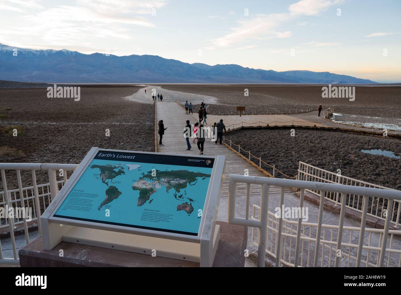 People on the path leading to Badwater Basin in Death Valley national ...
