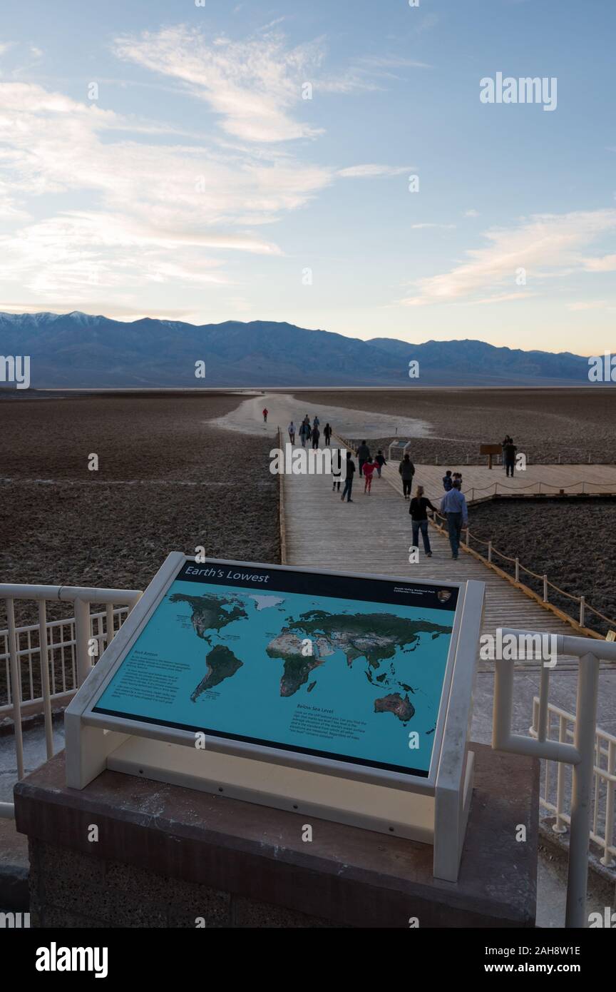 People on the path leading to Badwater Basin in Death Valley national ...