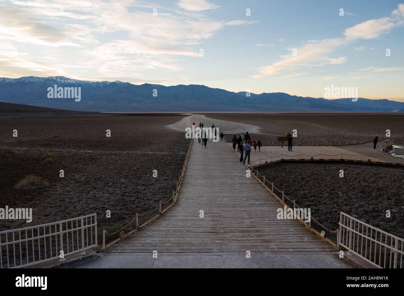 People on the path leading to Badwater Basin in Death Valley national ...