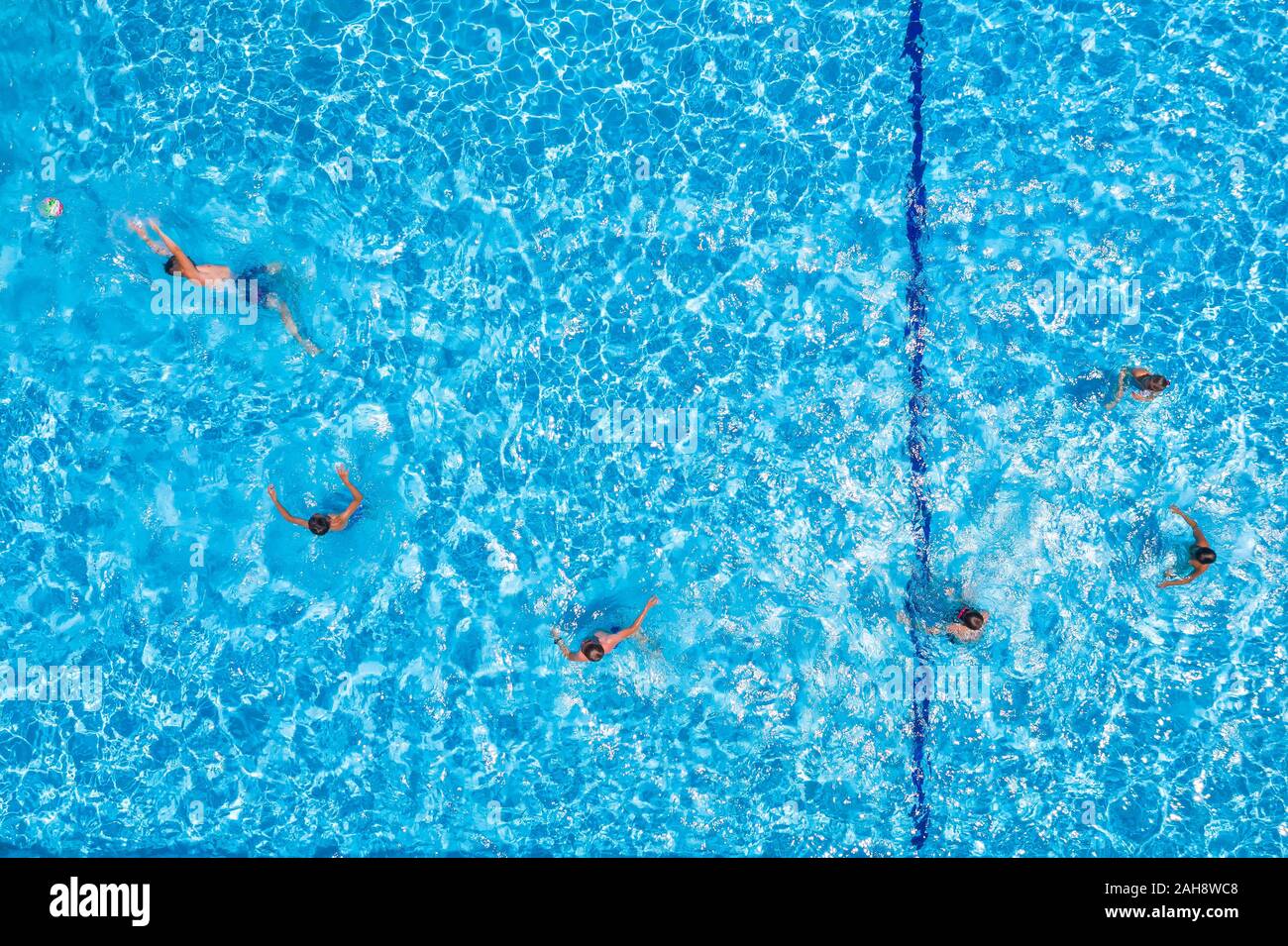 Swimming pool with playing people, overhead view Stock Photo
