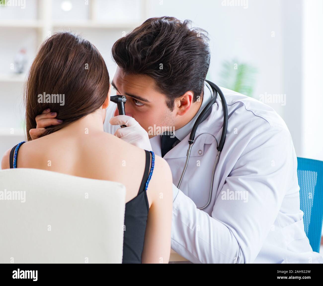 The doctor checking patients ear during medical examination Stock Photo