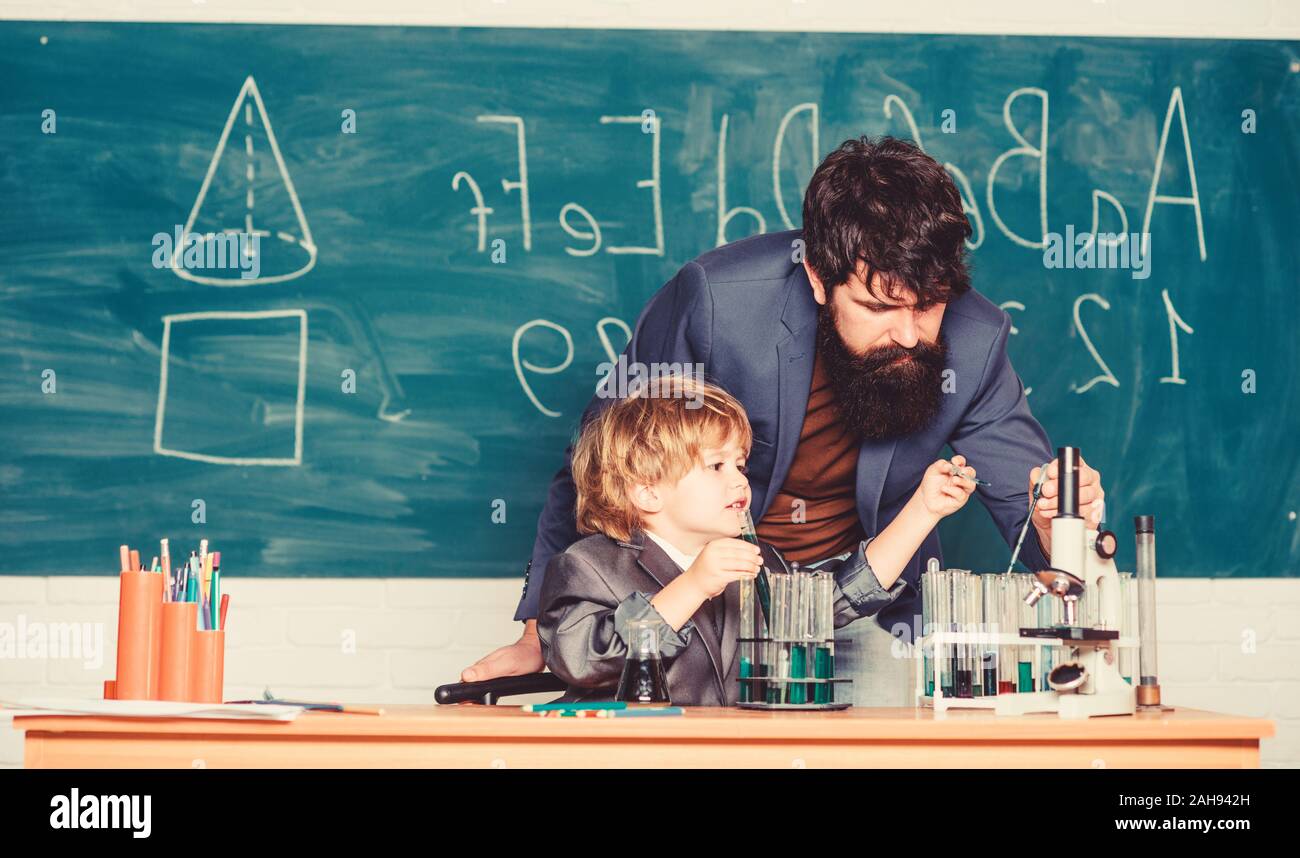 Basic Upbringing Teacher and child school classroom. Chemistry lesson. Lab experiment ...