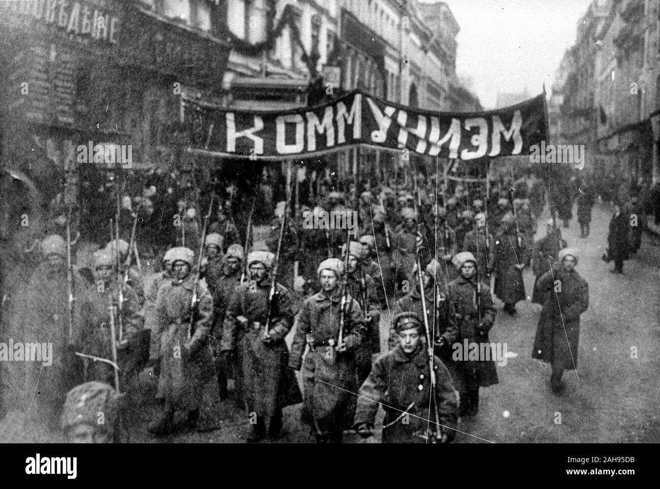 Armed soldiers carry a banner reading 'Communism', Nikolskaya street, Moscow, October 1917 Stock Photo