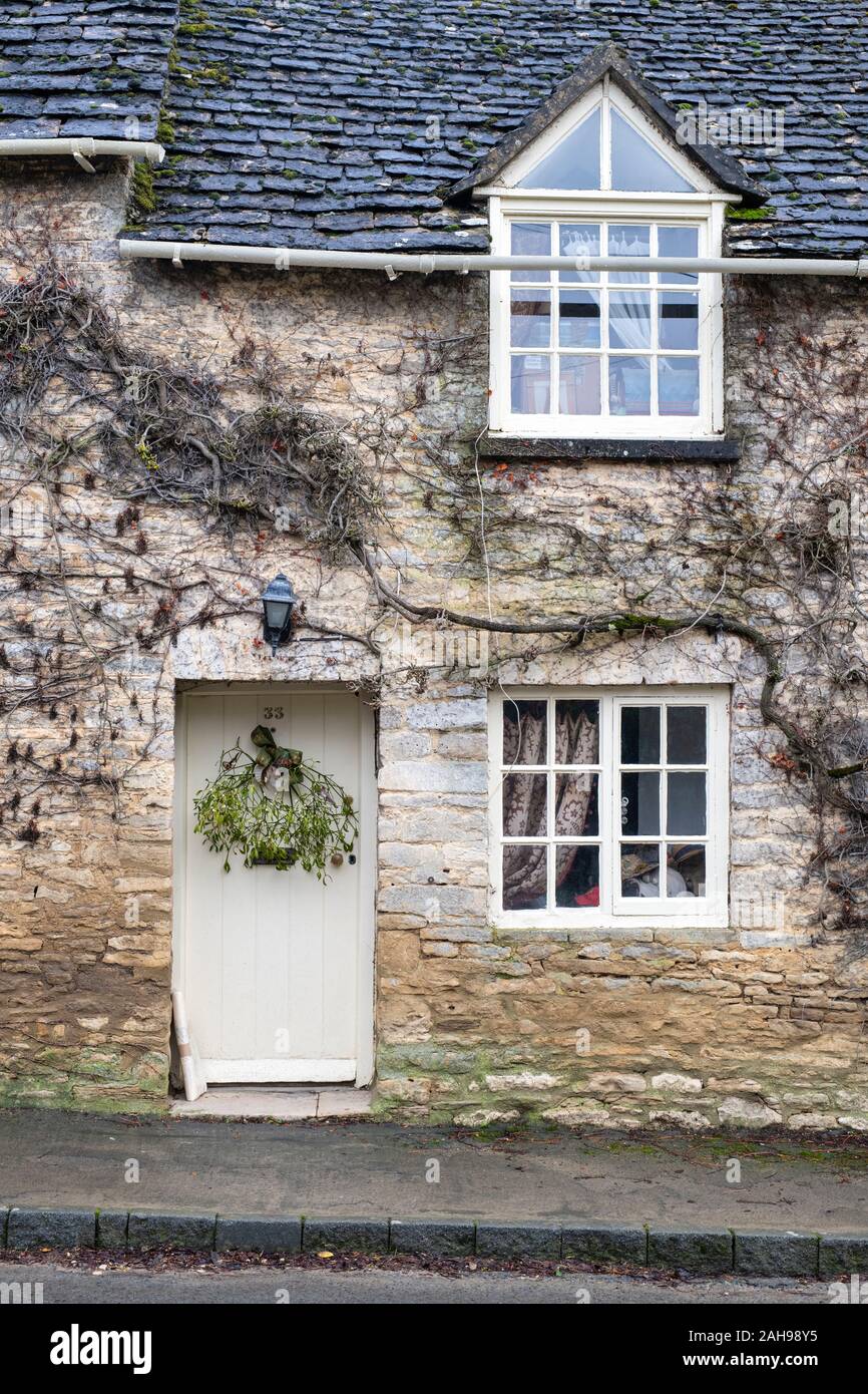 Mistletoe hanging on a cotswold cottage door in Coln St Aldwyns
