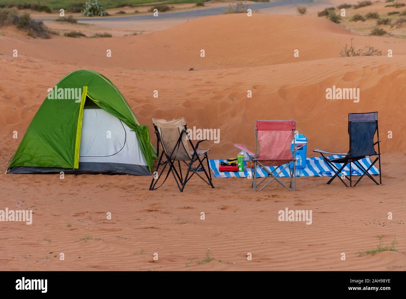 A green tent for family camping in the sand dunes of the United Arab