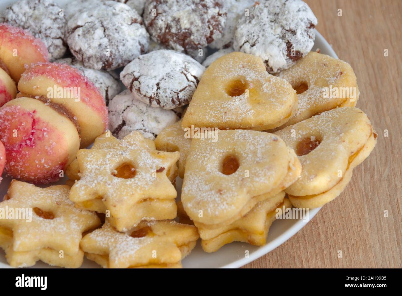 High angle view of plate with biscuit cookies on wooden table Stock Photo