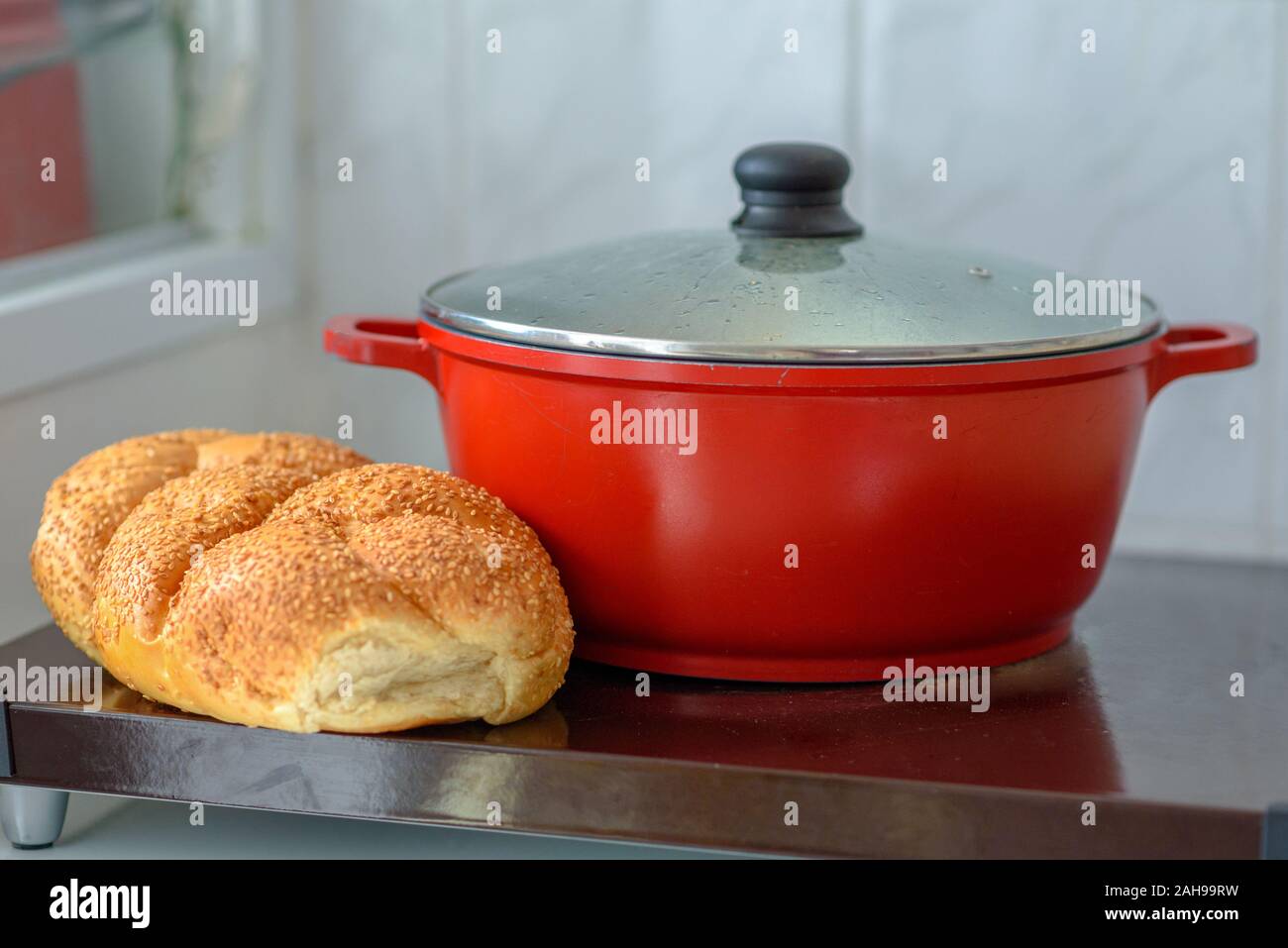 Hot plate for the Sabbath. Pot with traditional food and challah