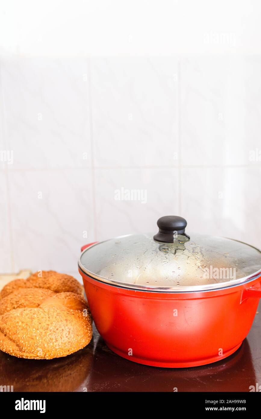 Hot plate for the Sabbath. Pot with traditional food and challah